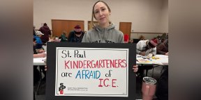 Teacher holding sign